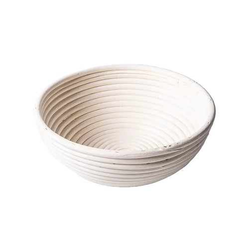 Round 10-inch Port Style Banneton basket for bread proofing, made of natural rattan with a coiled pattern.