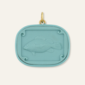 Teal pendant with fish cameo design on a white background