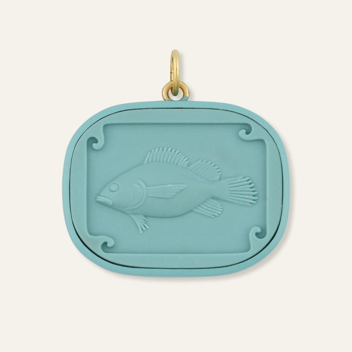 Teal pendant with fish cameo design on a white background