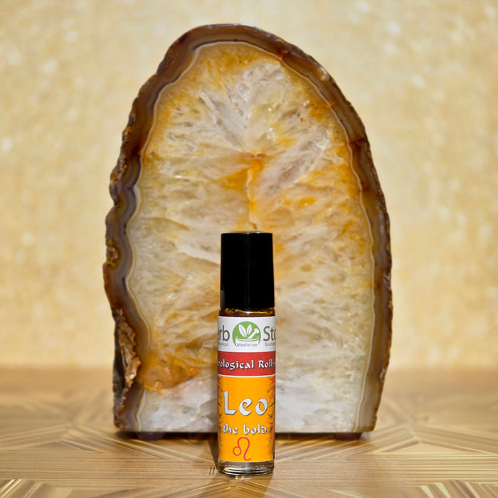 Leo Aromatherapy Roll-on bottle with a citrine crystal on a decorative background