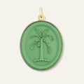 Green pendant with palm tree design on a white background. Palm cameo charm