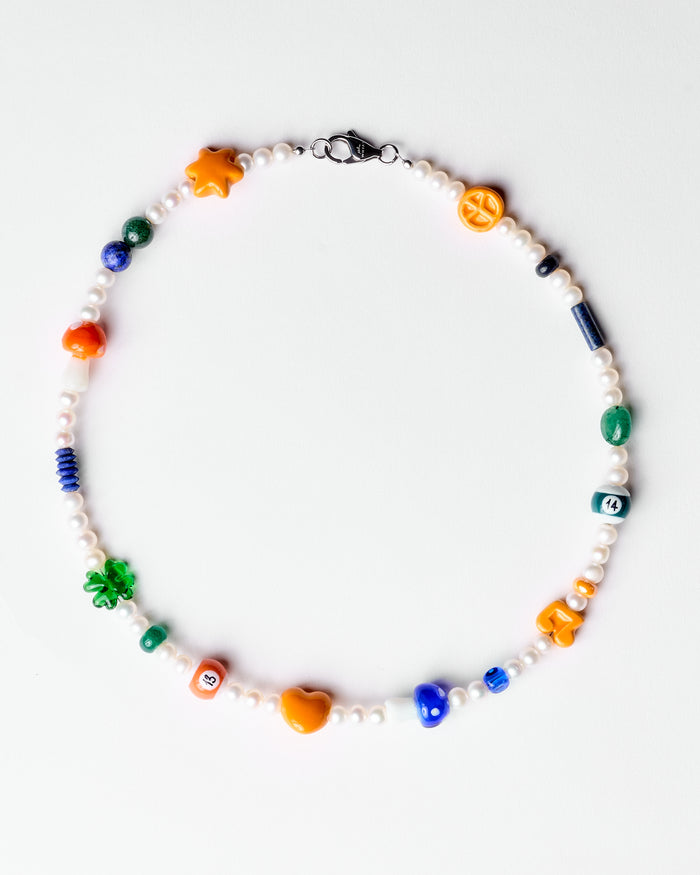 pearl necklace with orange and green charms
