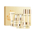 Sadoer Honey Luxury skincare set with creams, serums, and cleanser against golden box