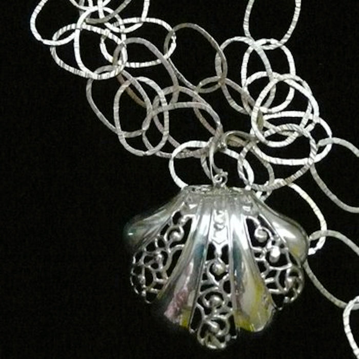 This large openwork scalloped seashell makes a beautiful choker...or, wear it as a single charm on a linked bracelet... for an eye-catching piece of whimsy.  Sterling Silverr Clam on the Half Shell Charm. Handmade in America with love, and hand-sgned. Accompanied by a long leather cord or vintage inspired ribbon. 2-1/2" x 2-1/4" Also available as shoe clip.
