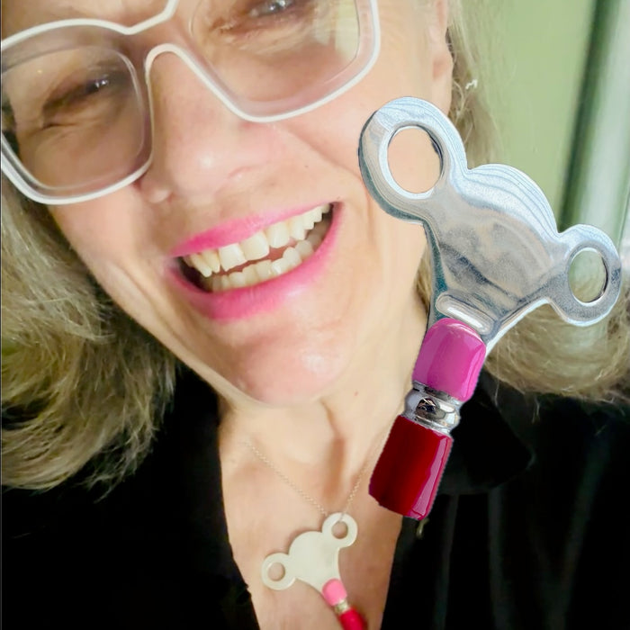 The PERSONAL AUTONOMY KEY is Sterling Silver with hand enameled Hot Pink and Red around the bottom. Approximately &nbsp; 2" x 2". Handmade, hand-enameled and hand-signed Sterling Silver Large Clock-Winding Key. If you are the keeper of the door, then this is a MUST to add to your collection of wearable KEYS! Sterling Silver PERSONAL AUTONOMY KEY Charm comes with a Sterling Silver chain like the one shown here. Comes in branded cotton pouch and gift boxed.