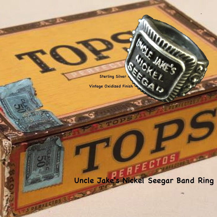Even if you are not a cigar aficionado, this vintage cigar band ring is "smoking". The first in what will be an expansive and whimsical collection,  this 3D version of an actual antique "Seegar" band--the first of its kind. Sterling Silver in my antique satin oxidized finish to bring the old cigar band to life once again!  Top 1/2" wide approximately.  Made in the USA by hand. Hand signed.  Sterling Silver Uncle Jake's Nickel Seegar Cigar Band Ring.  Be sure to check out my other two cigar band rings--Mild