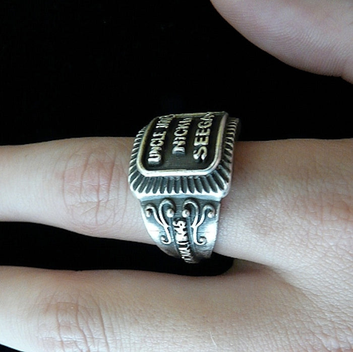 Even if you are not a cigar aficionado, this vintage cigar band ring is "smoking". The first in what will be an expansive and whimsical collection,  this 3D version of an actual antique "Seegar" band--the first of its kind. Sterling Silver in my antique satin oxidized finish to bring the old cigar band to life once again!  Top 1/2" wide approximately.  Made in the USA by hand. Hand signed.  Sterling Silver Uncle Jake's Nickel Seegar Cigar Band Ring.  Be sure to check out my other two cigar band rings--Mild